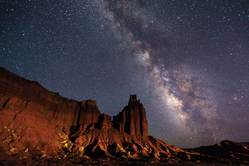 The Milky Way arches over Capitol Reef National Park’s iconic Chimney Rock. Photo by Jacob W. Frank. Communication between Heaven and Earth....